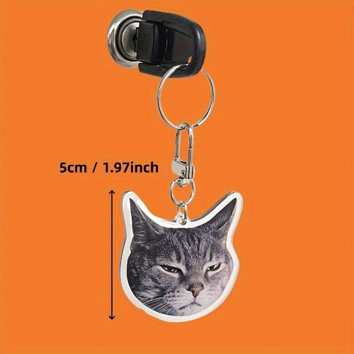 Cat-shaped keychain with dimensions on an orange background