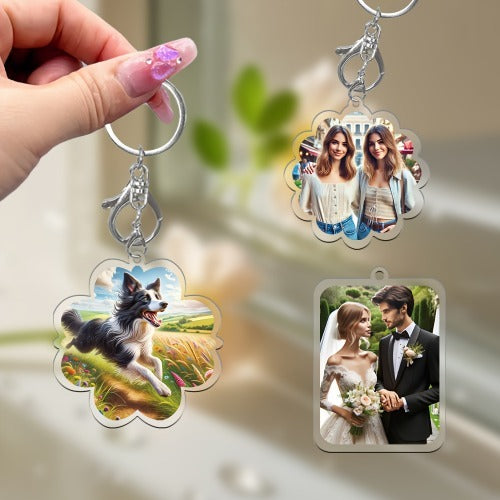 Three keychains with different designs held by a hand against a blurred background
