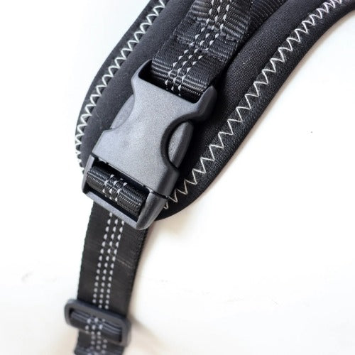 Close-up of a black strap with a gray buckle on a white background