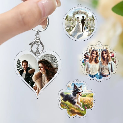 Heart-shaped keychain with photo charms featuring a couple, a dog, and two women.
