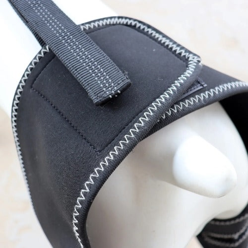 Black neoprene wrist support with gray strap on a white background