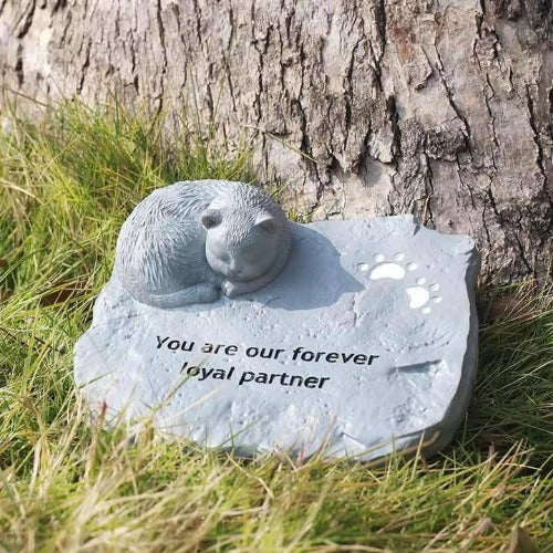 Pet tombstone with paw prints and engraved “In Memory”